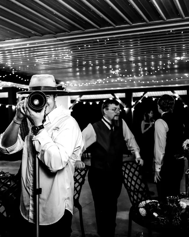 Filming an evening event under string lights
